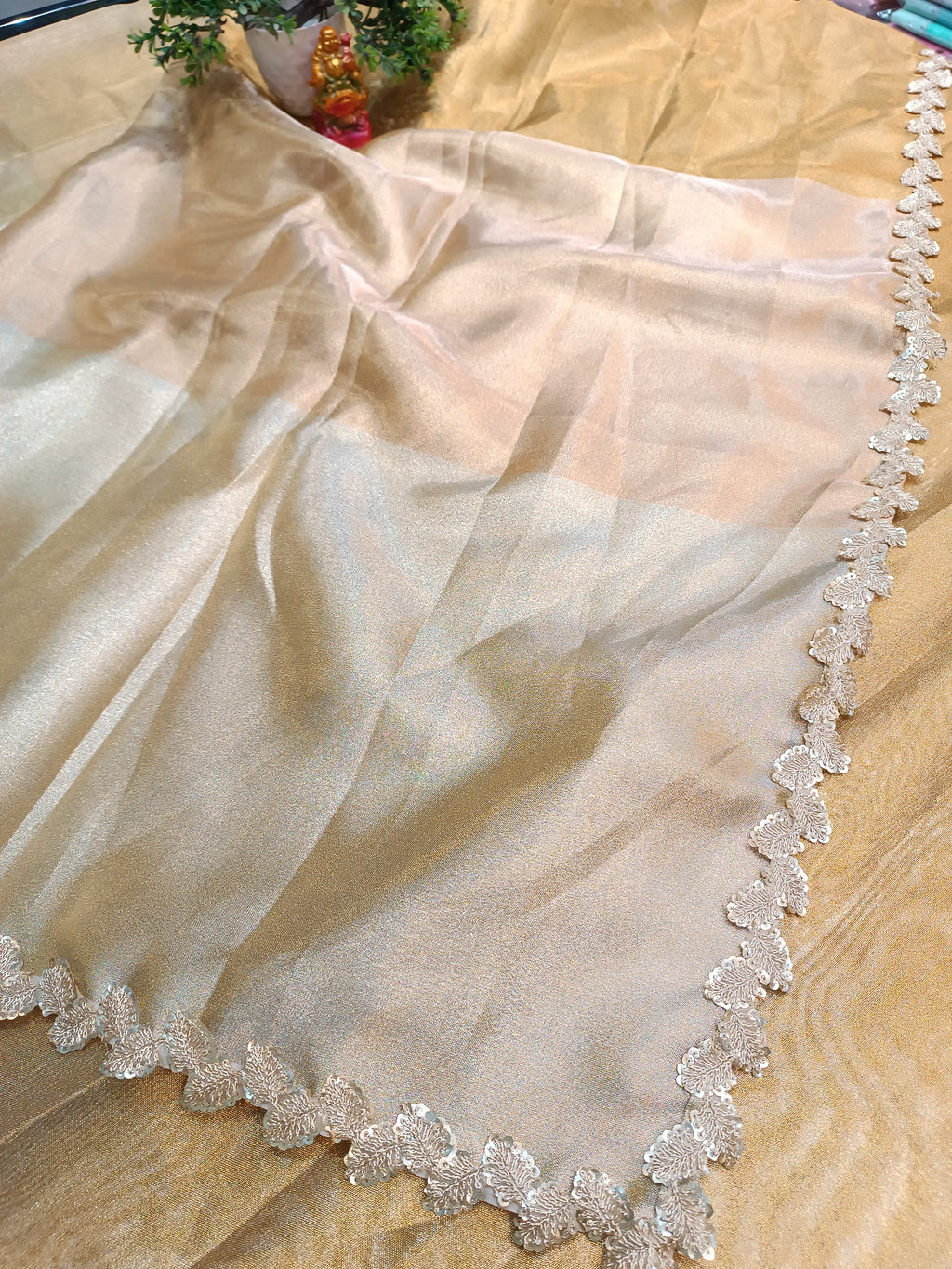 Sheer fabric with decorative lace edge on a beige background