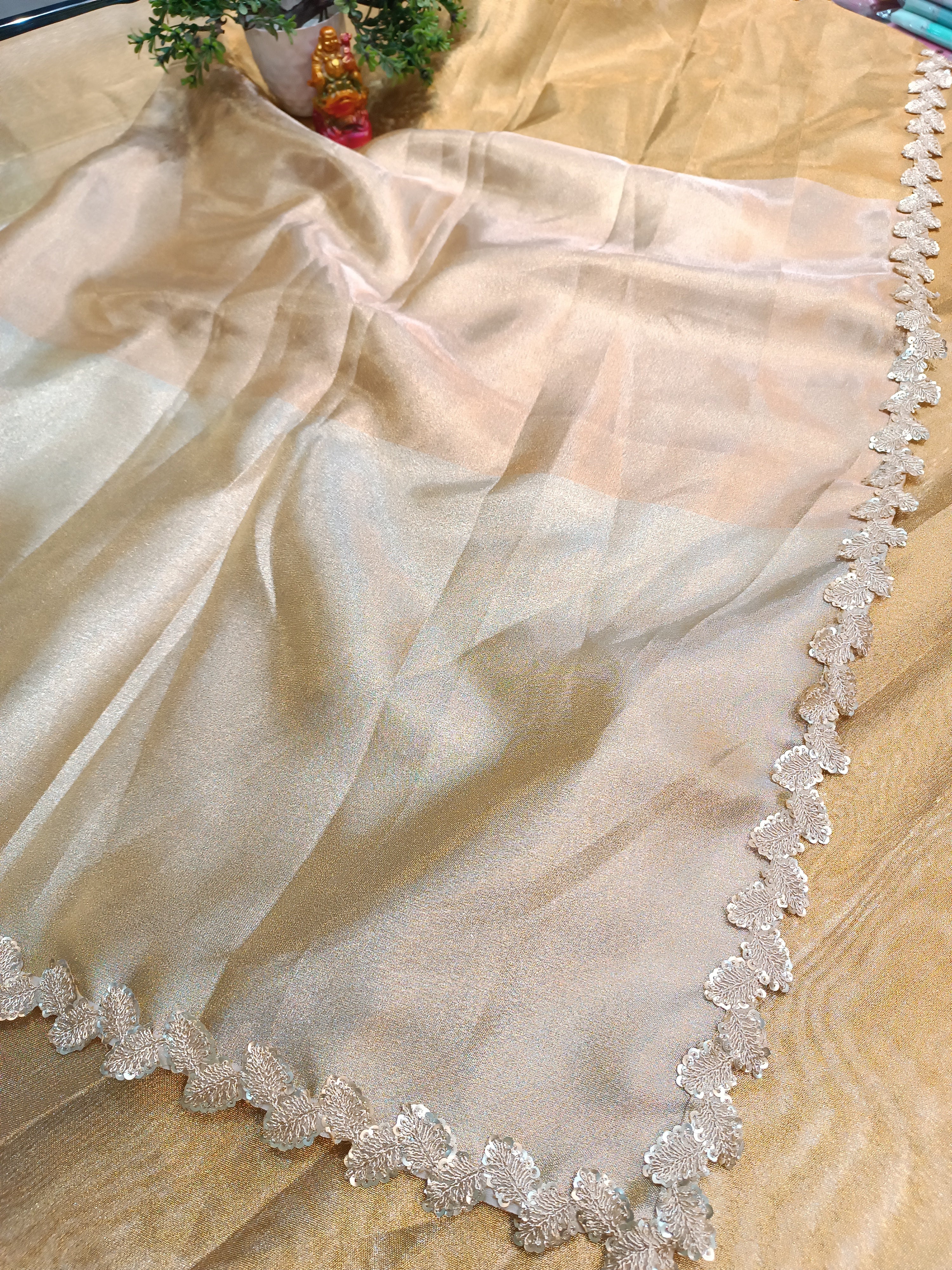Sheer fabric with decorative lace edge on a beige background
